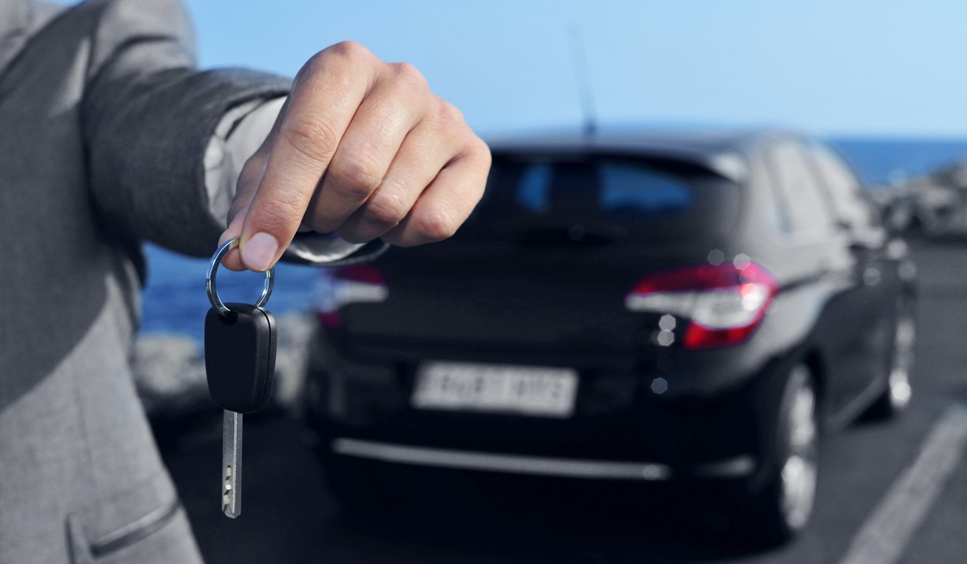 man offering a car key to the observer